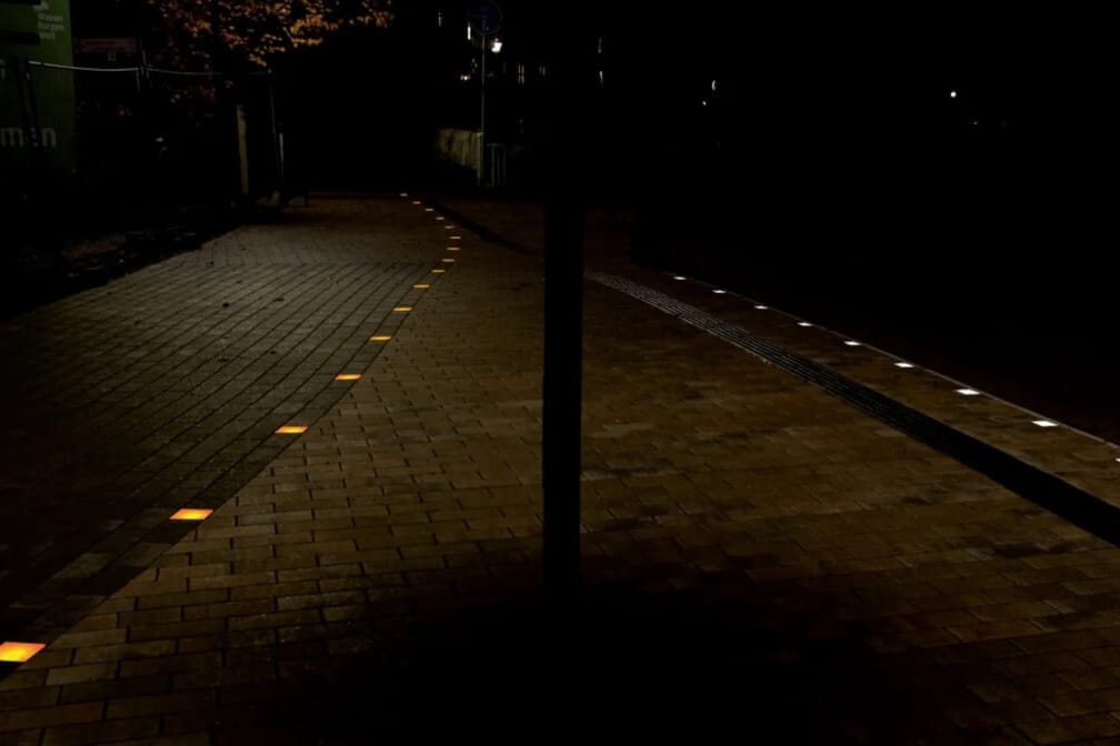Cycle path at night, illuminated markers line the route in the direction of travel