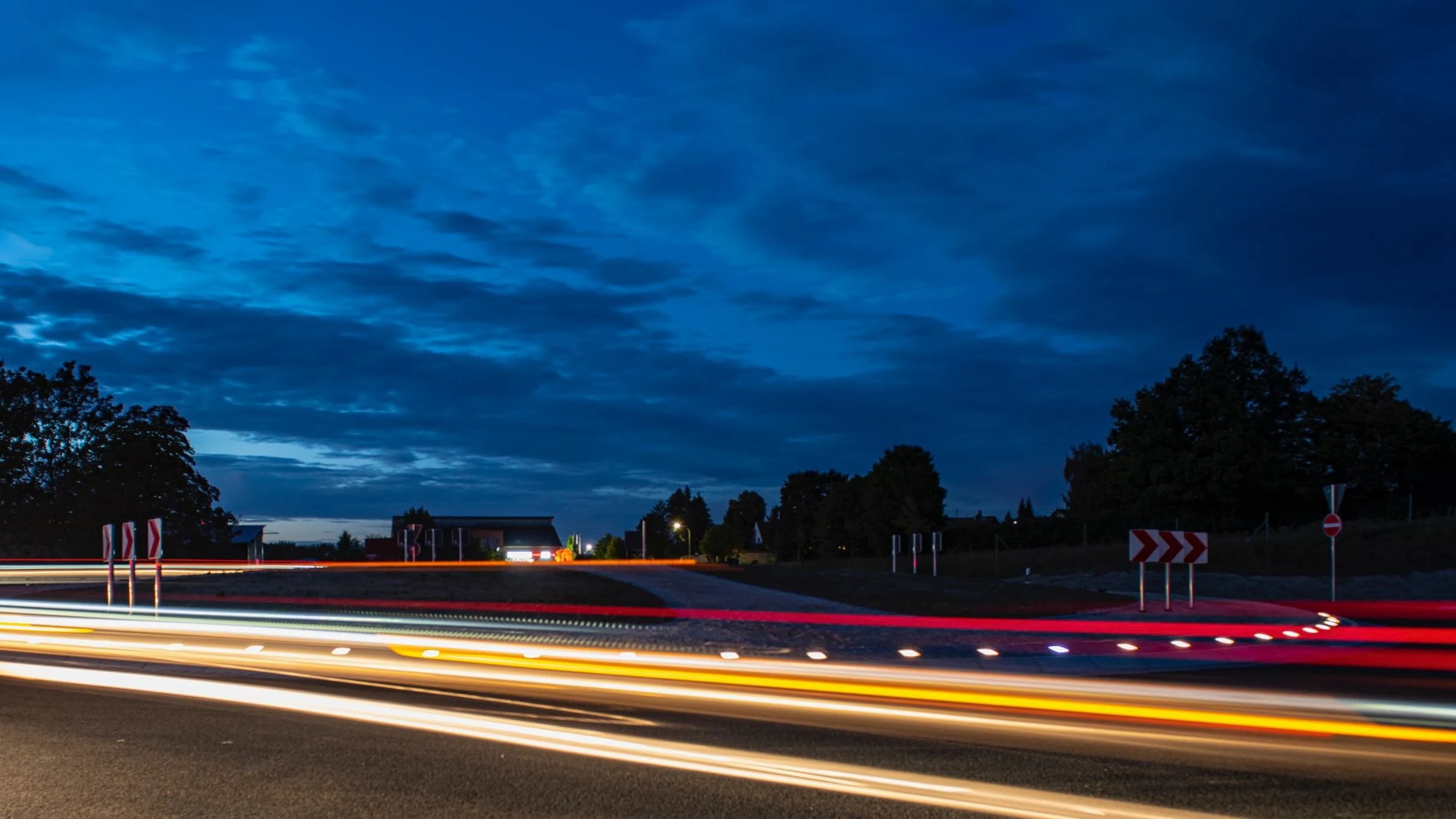 Roundabout exit at blue hour, Paver Lights along the curb