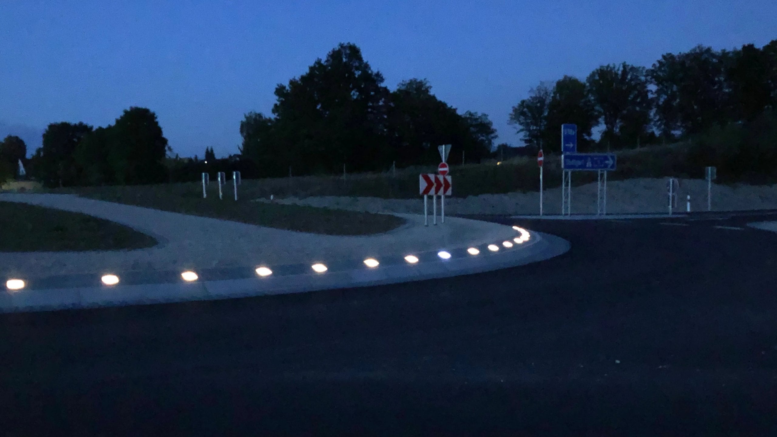 Paver Lights along the central island of a roundabout at dusk
